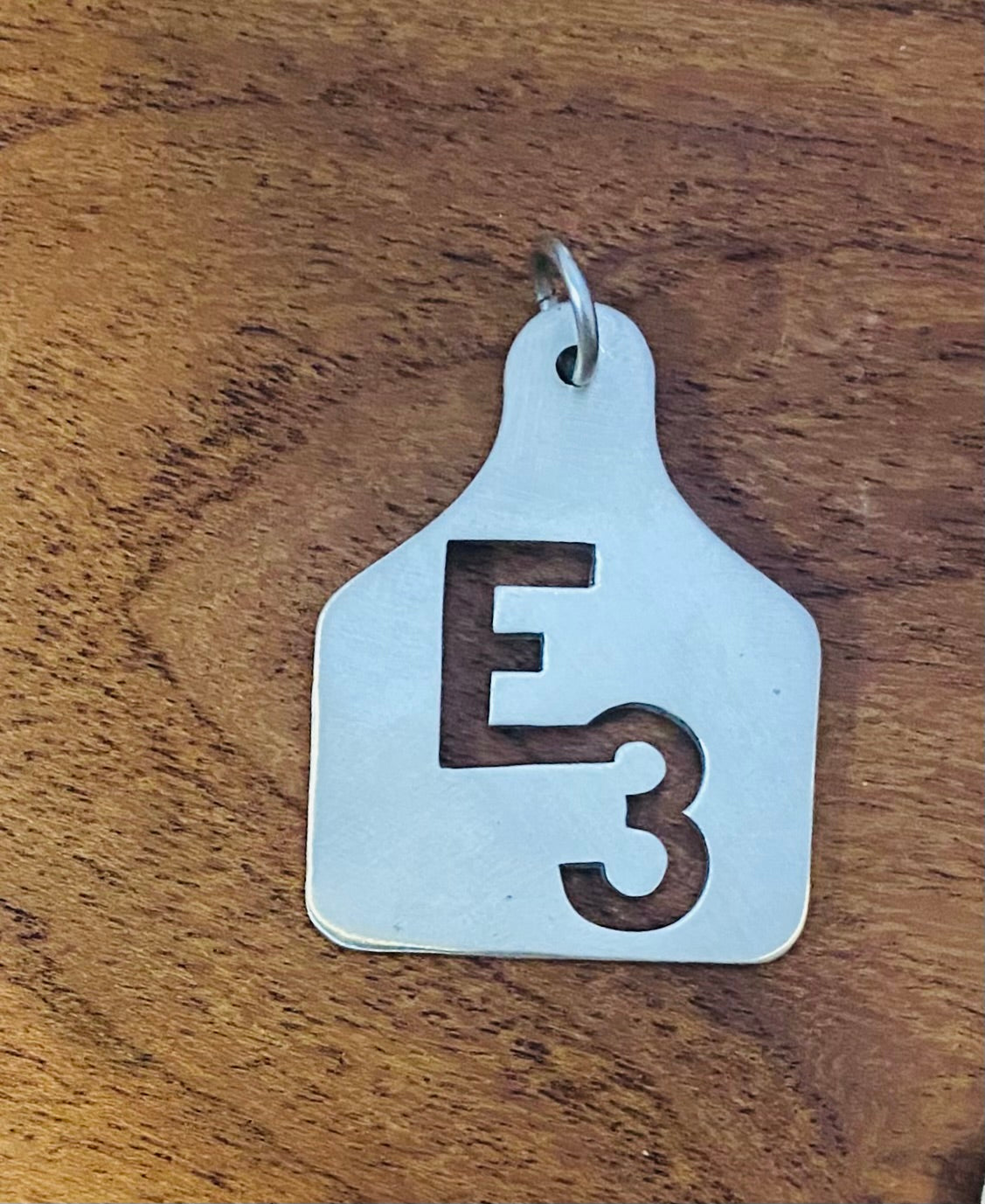 Large hand cut sterling silver ear tag pendant with the E3 ranch brand